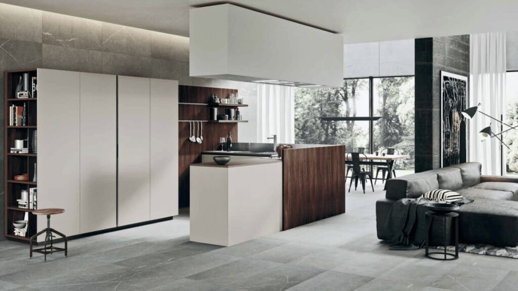 Cocina integrada en salón moderno, con mobiliario en tonos beige y madera oscura, diseñada en concepto abierto con comedor al fondo.